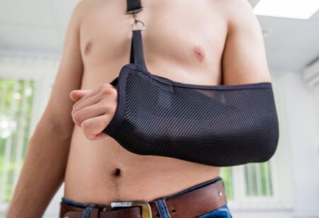 Man with a arm sling. Broken arm, shoulder.の写真素材
