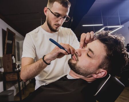 Young man with trendy haircut at barber shop.の写真素材
