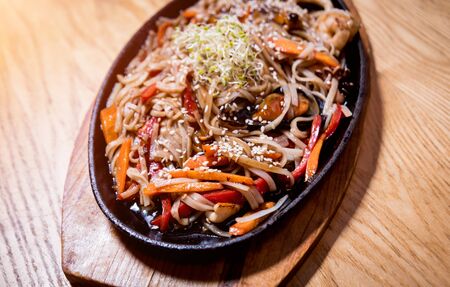 Chinese noodles with mussels and shrimps on the wooden table. Restaurant. Backgroundの写真素材