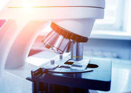 Microscope with metal lens at laboratory. Medical equipment. Medical background
