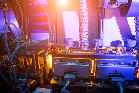 The plastic bottle blowing machine. PET preforms for blowing of plastic bottles. Heating process. High technologyの写真素材