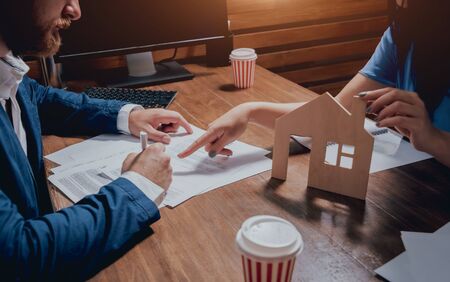 Man sign a home insurance policy on home loans. Estate agent with customerの写真素材