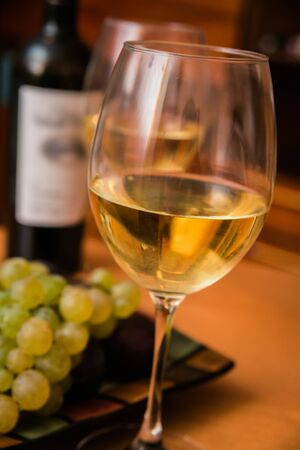 Wine in the glasses with grapes. On the table. Background.の写真素材