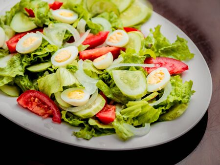 Salad. Lettuce, cucumbers, tomatoes, onions, quail eggs. restaurantの写真素材
