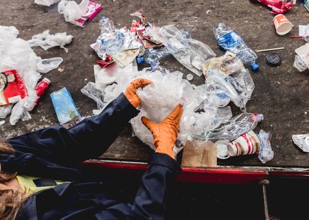 At modern recycling plant. Separate garbage collection. Workers sorting trash to be processed. Trash sorting. Backgroundの写真素材