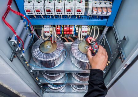 Electrical measurements with multimeter tester. Modern electrical background.の写真素材