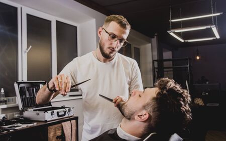 Young man with trendy haircut at barber shop.の写真素材