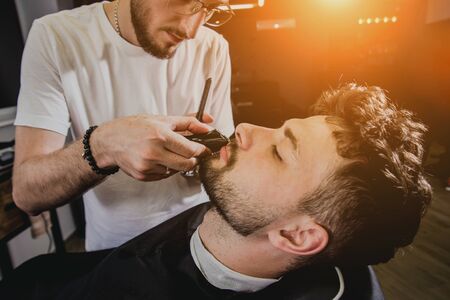 Young man with trendy haircut at barber shop.の写真素材