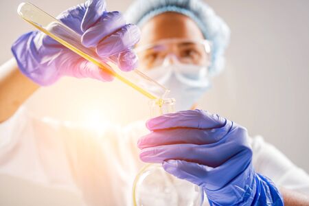 Scientist pouring organic oil. Beauty and cosmetics sciences.の写真素材