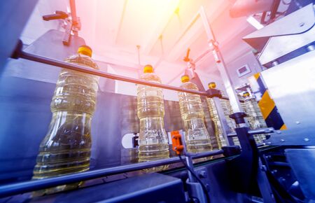 Bottling line of sunflower oil in bottles. Vegetable oil production plant. High technology. Industrial backgroundの写真素材