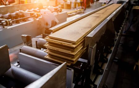 Production line of the wooden floor factory. CNC automatic woodworking machine. Industrial backgroundの写真素材