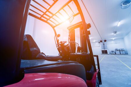 Forklift in a large industrial freezer warehouse. Empty warehouse for vegetable storage. Backgroundの写真素材