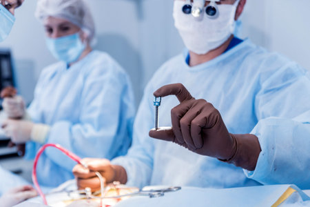 Spinal surgery. Surgeon show polyaxial screw in operating room