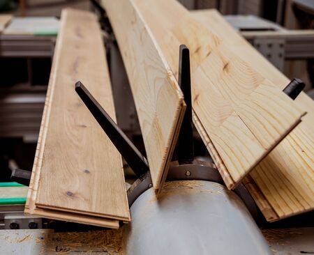 Production line of the wooden floor factory. CNC automatic woodworking machine. Industrial backgroundの写真素材