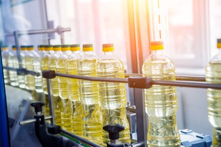 Bottling line of sunflower oil in bottles. Vegetable oil production plantの写真素材