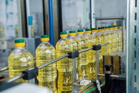 Bottling line of sunflower oil in bottles. Vegetable oil production plantの写真素材