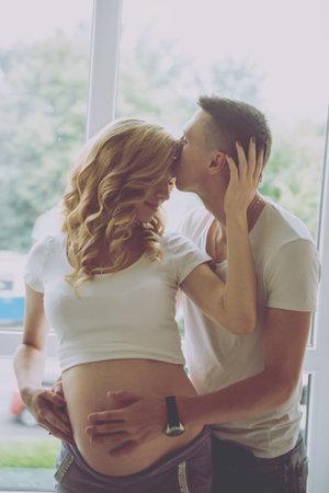 Young pregnant woman and her husband. Waiting for baby
