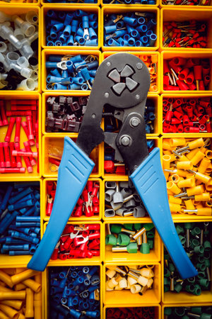 Electrical equipment. Electricity cable and crimper. Background and texture