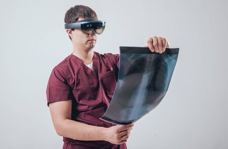 Doctor uses augmented reality goggles to exam x-rays filmの写真素材