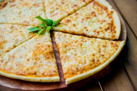 Large pizza on a wooden table. Restaurantの写真素材
