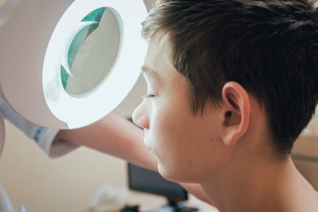 Concentrated dermatologist using medical loupe in the clinic
