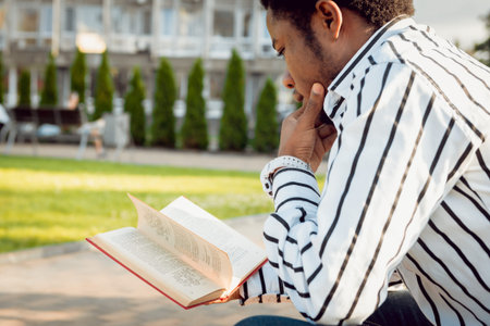 African student in the park. Beautiful background