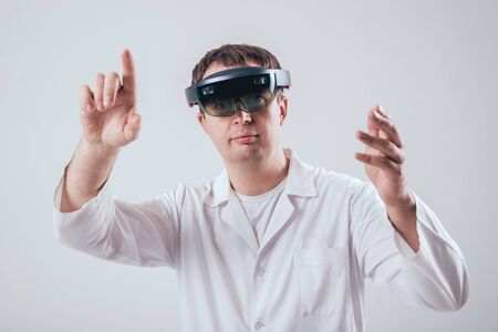 Doctor uses augmented reality goggles. Modern technology.の写真素材