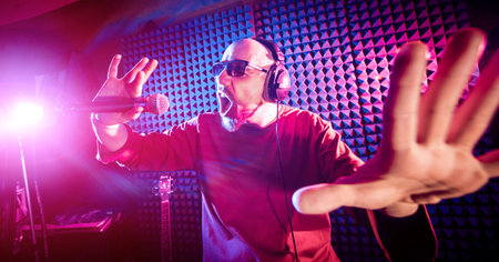 The singer sings with a microphone in the recording studio. Modern background
