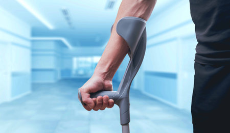 Injured man trying to walk on crutches. Blurred background