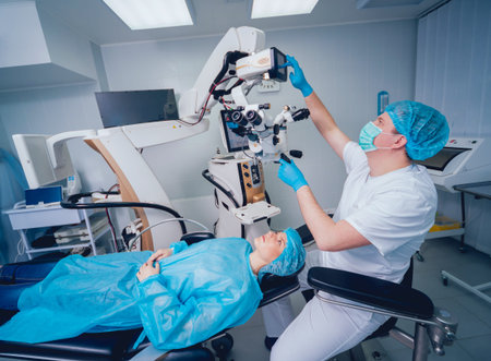 Eye surgery. A patient and surgeon in the operating room during ophthalmic surgery. Patient under...