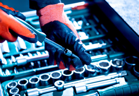 Tools at the hands. Auto repair service
