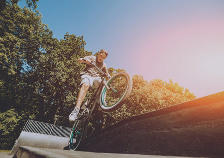 Bmx rider performing tricks at skatepark. Background.の写真素材