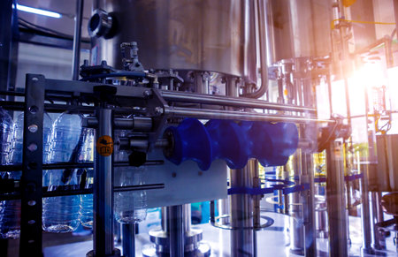 Bottling line of sunflower oil in bottles. Vegetable oil production plant.