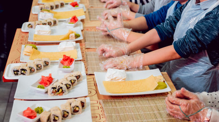 Children prepare sushi and rolls. Master-class restaurant. Backgroundの写真素材
