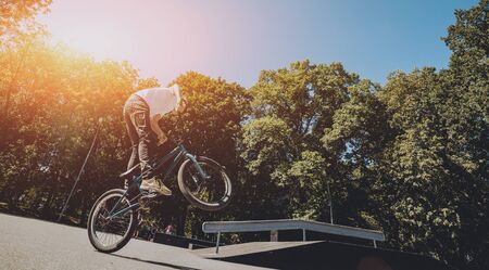 Bmx rider performing tricks at skatepark. Background.の写真素材