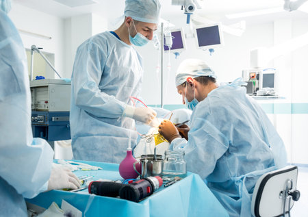 Brain surgery. Group of surgeons in operating room with surgery equipment.