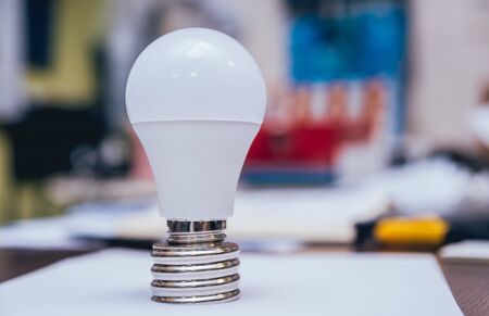 Man's hands holding shiny lamp. Light backgroundの写真素材