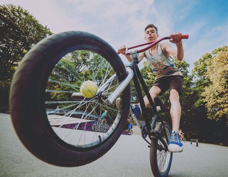Boy riding a bmx in a park.の写真素材