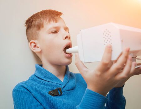 Treatment and warming-up the larynx of a young boy.の写真素材