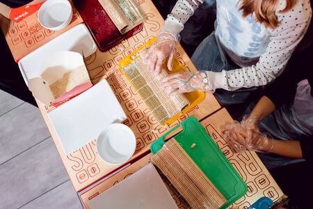 Children prepare sushi and rolls. Master-class restaurant. Backgroundの写真素材