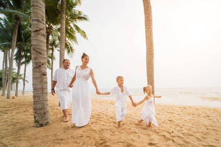 Happy young family on the sunset at the beach. Lifestyleの写真素材