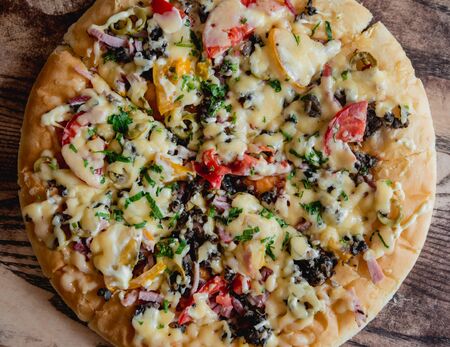 Large pizza on a wooden table. Restaurant.の写真素材
