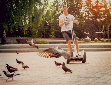 Young man driving on  two-wheeled in the park.