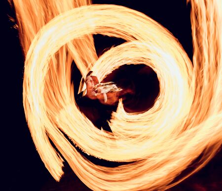 Fire show. Fire performance at the night.の写真素材