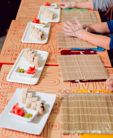 Children prepare sushi and rolls. Master-class restaurant. Backgroundの写真素材
