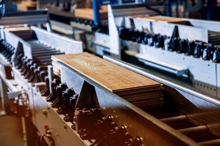 Production line of the wooden floor factory. CNC automatic woodworking machine.の写真素材