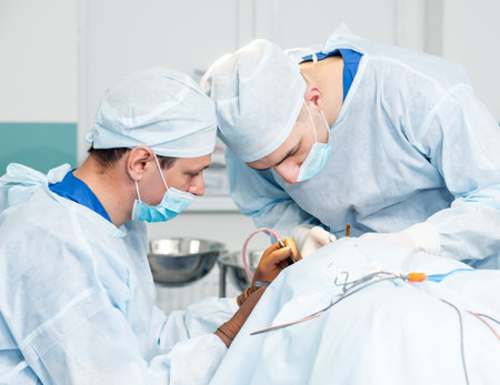 Brain surgery. Group of surgeons in operating room with surgery equipment.