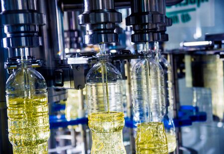 Bottling line of sunflower oil in bottles. Vegetable oil production plant. High technology. Industrial backgroundの写真素材