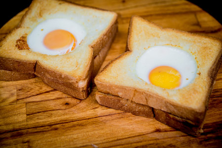 Toast bread with egg inside on the board. The Restaurant