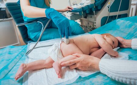 Doctor and little boy patient. Ultrasound equipment. Diagnostics. Sonography. Hip dysplasiaの写真素材